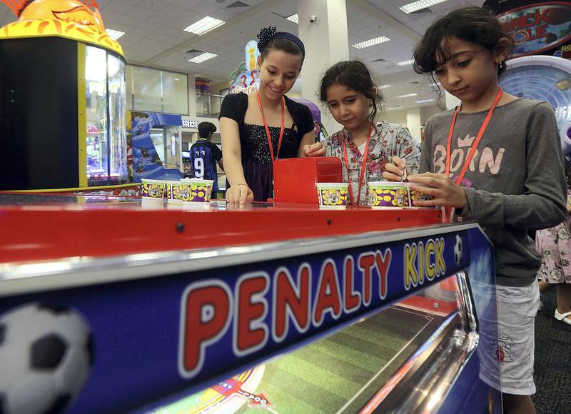 Dubai, June, 04, 2018: Orphan Childrens ( L to R ) Jana Arafa, Noor Mohammed,and Maya Mohammed play games after  iftar hosted by Ibn Battuta Mall for orphans at the Chuck E Cheese restaurant at theI BN Battuta mall in Dubai. Satish Kumar for the National / Story by Patrick Ryan