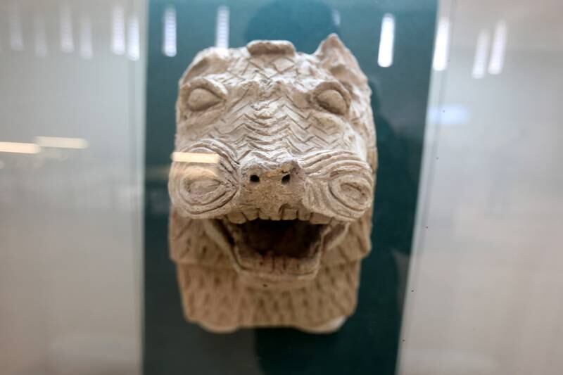 A lion head made of pottery dated to 2112-2004 BC is on display.