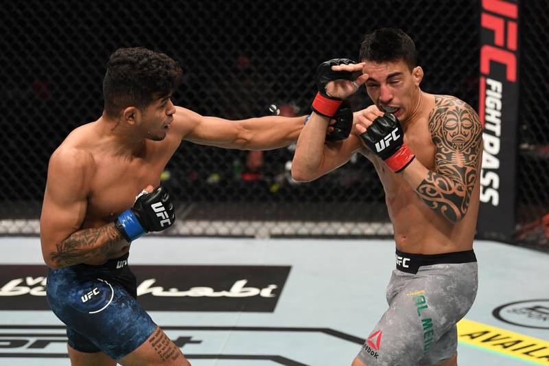 Jonathan Martinez punches Thomas Almeida during their lightweight bout at UFC Fight Night. Getty