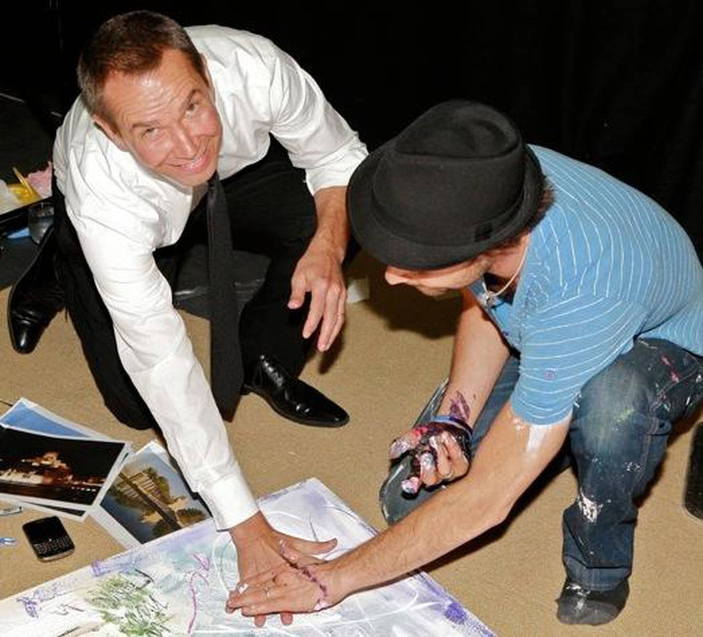Arist Sacha Jafri and Jeff Koons making one of Jafri's hand-printing paintings. Courtesy Sacha Jafri