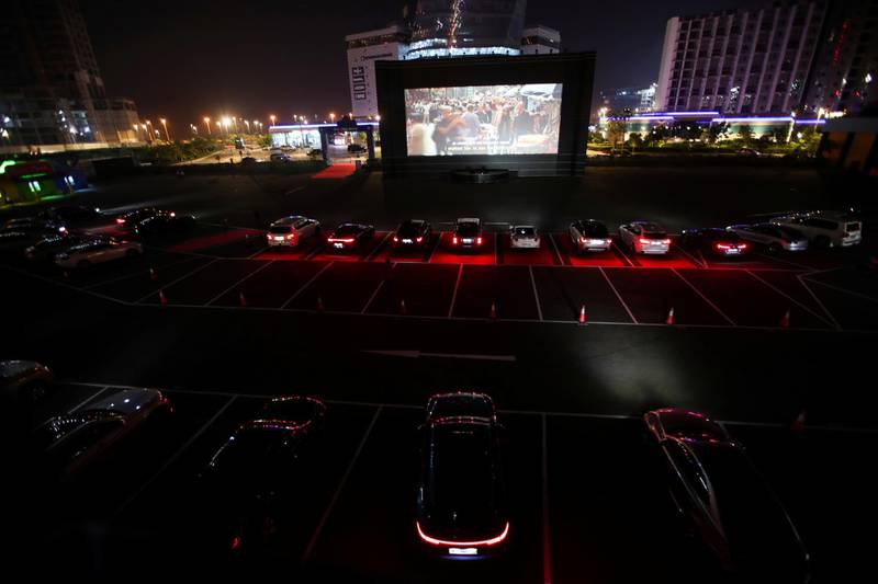 People sit in their cars watching a movie in a drive-in cinema at Bahrain Bay in Manama, Bahrain. Reuters