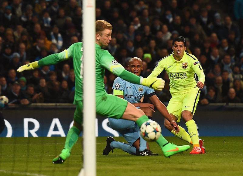 Luis Suarez of Barcelona scores the opening goal past Joe Hart of Manchester City to make it 1-0 on Tuesday night in the first leg of their Champions League last 16 tie. Laurence Griffiths / Getty Images