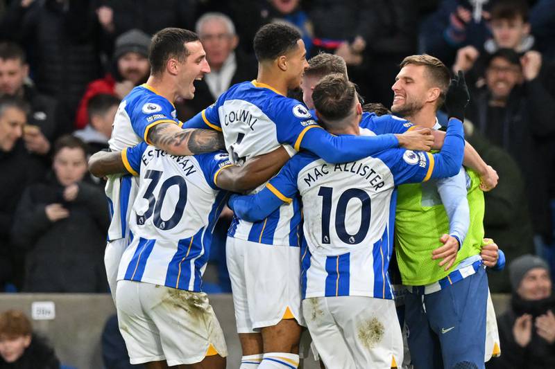 Brighton's midfielder Solly March celebrates with teammates after scoring the opening goal. AFP