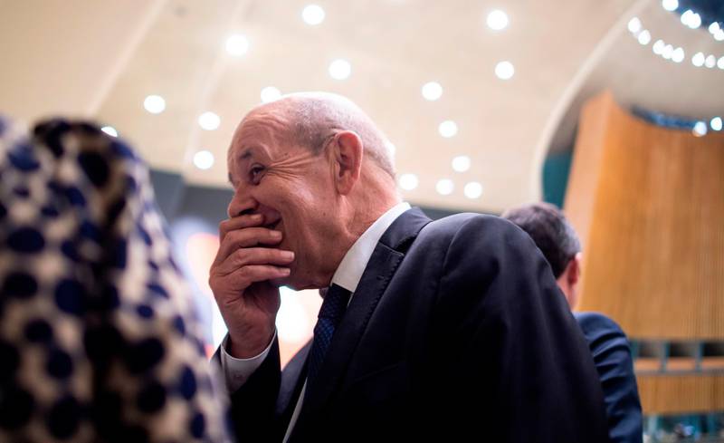 French Foreign Minister Jean-Yves Le Drian speaks with his delegation during the United Nations General Assembly at the United Nations Headquarters in New York City.  AFP
