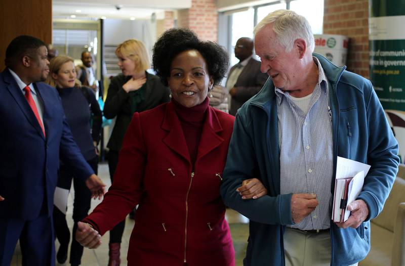 Malcolm McGowan, father of South African Stephen McGowan, who was kidnapped by al Qaeda from the Mali tourist town of Timbuktu in 2011 and has been released and is back home, chats to foreign minister Maite Nkoana-Mashabane after a media briefing in Pretoria, South Africa August 3, 2017. REUTERS/Siphiwe Sibeko
