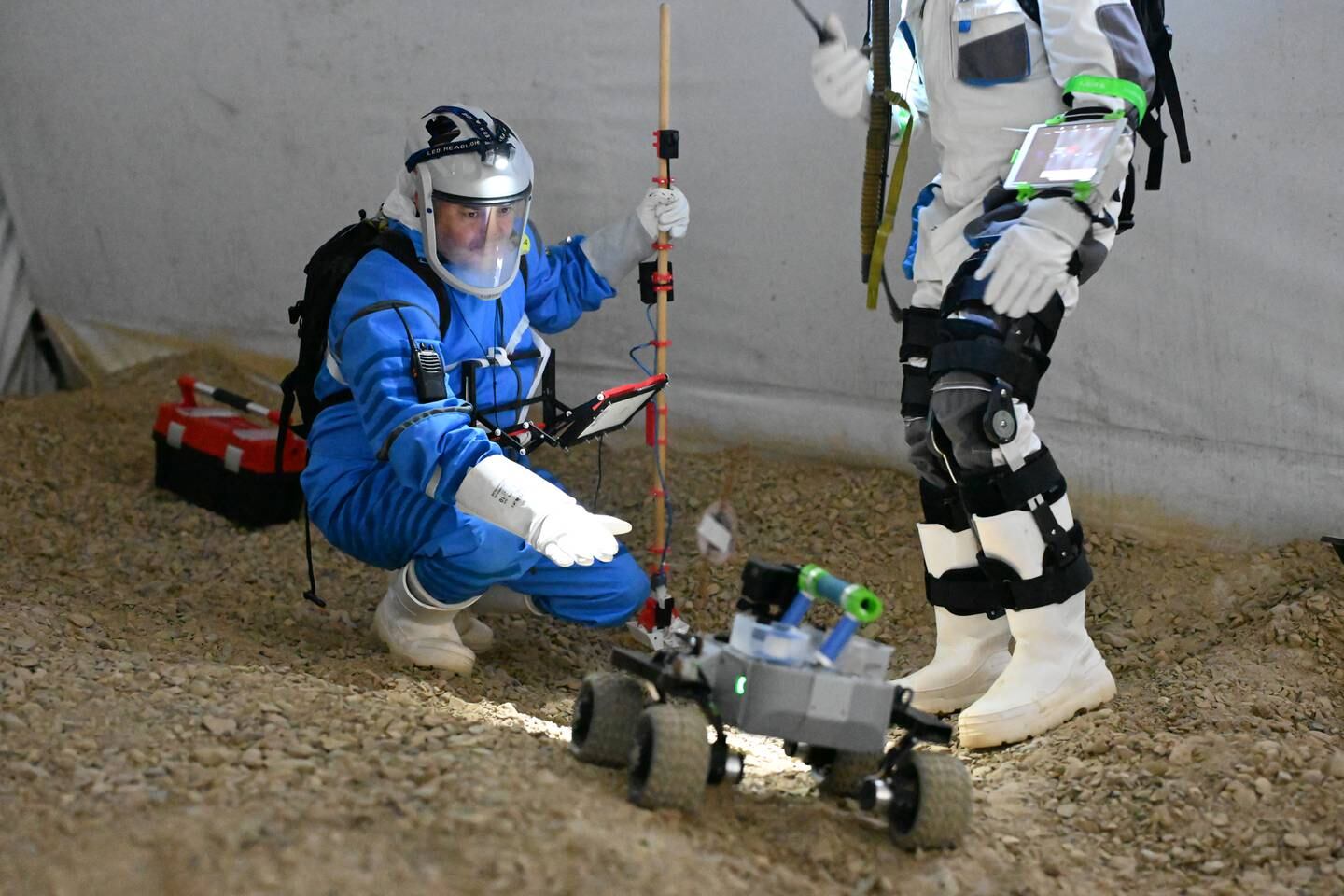 An astronaut trainee simulates gathering a surface sample on the moon. The simulation, also known as an analog mission, trains aspiring astronauts on what it's like to conduct missions off-planet, The three-week training period is spent entirely underground to ensure conditions are as similar to those off-planet as possible. Photo: LunAres Research Station
