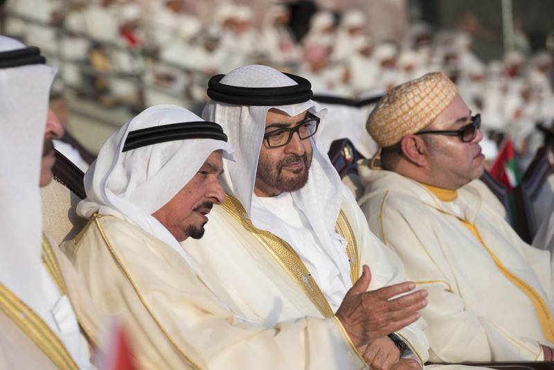 Sheikh Mohammed bin Zayed, Crown Prince of Abu Dhabi and Deputy Supreme Commander of the UAE Armed Forces, second right,  speaks with Sheikh Humaid bin Rashid Al Nuaimi, UAE Supreme Council Member and Ruler of Ajman, third right. Seen with them are King Mohammed VI of Morocco, right. Ryan Carter / Crown Prince Court - Abu Dhabi