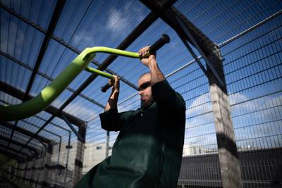 A migrant works out in the recreation area of the Centre de Retention Administrative, a migrant detention centre in Vincennes, France. AFP