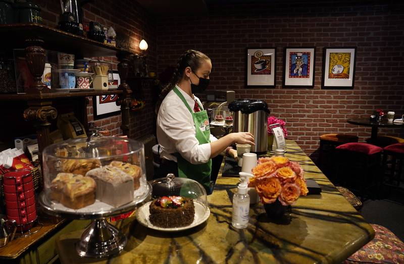 Sara Olson makes coffee for visitors to the 'Friends'-inspired Central Perk Cafe set on the  Warner Bros Studio Tour.