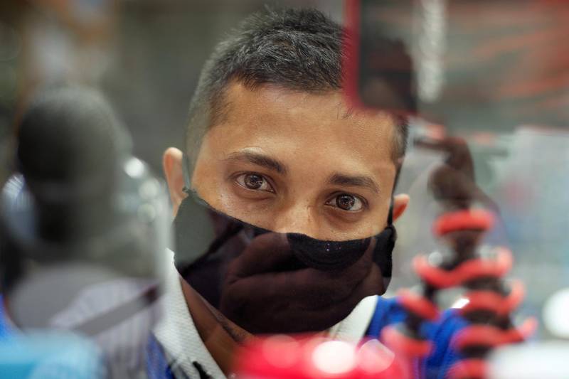 A vendor wears a protective face mask following the coronavirus outbreak, as he looks on at his shop in local souq, in Manama, Bahrain. Reuters