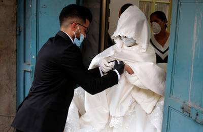 Palestinian bride Bara'a Amarneh and her groom Imad Sharaf leave the beauty salon.  AFP