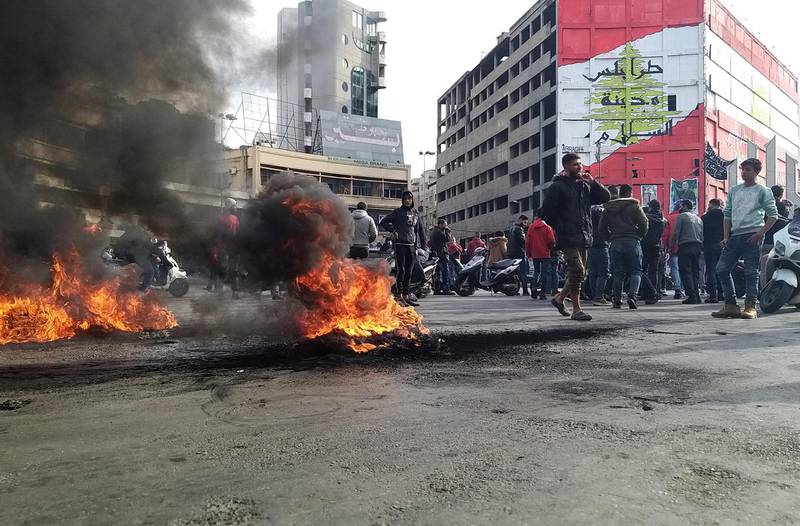 Demonstrators gather near burning tires during a protest against the lockdown and worsening economic conditions, amid the spread of the coronavirus disease, in Tripoli, Lebanon. Reuters
