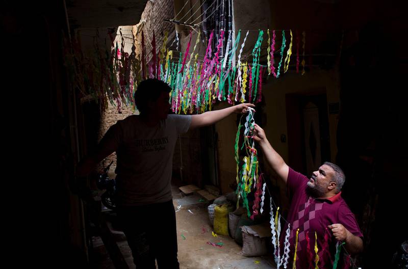 A man assists in the installation of Ramadan ornaments at the streets of Giza. EPA