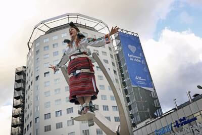 Ukrainian mezzosoprano Maria Melnychyn performs with the La Fura dels Baus theatre company at Vall d'Hebron hospital, in Barcelona, Spain, to mark the second anniversary of the beginning of the pandemic. EPA