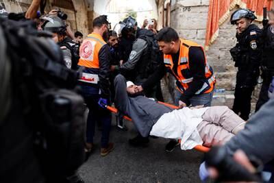 An injured man is stretchered to safety. The foreign ministry denied reports on social media that police had entered the mosque building itself during the violence. Reuters