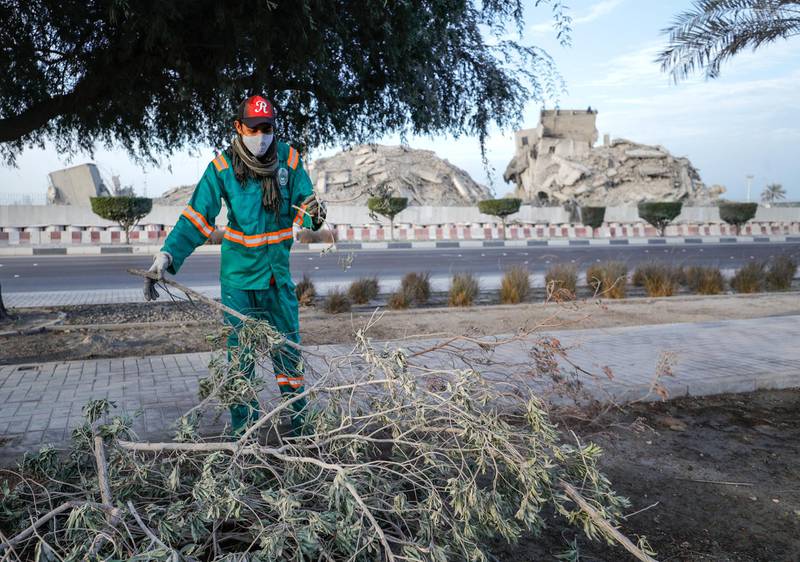 Abu Dhabi, United Arab Emirates, November 28, 2020.  The surrounding areas the morning after the demolition of the Mina Zayed Plaza.  A cleaner at the Al Mina Fruits and Vegetable Market.Victor Besa/The NationalSection:  National News