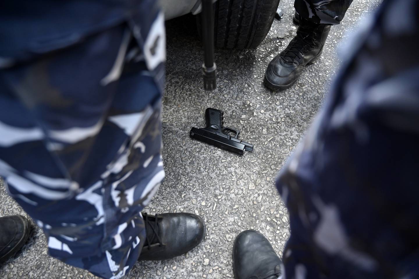 Members of the Lebanese security forces stand next to a toy gun that was used by depositors in a hostage situation at a Blom Bank branch in Beirut. EPA