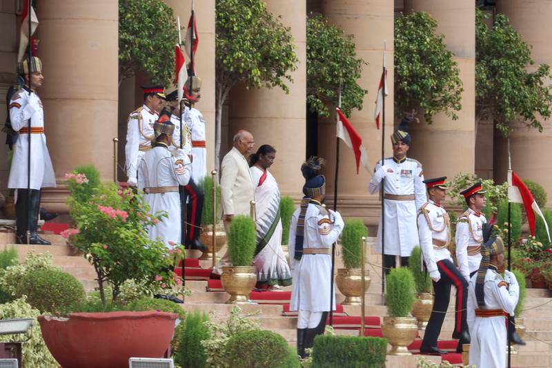 Ms Murmu and Mr Kovind arrive at the Central Hall of Parliament for the swearing-in ceremony. Reuters