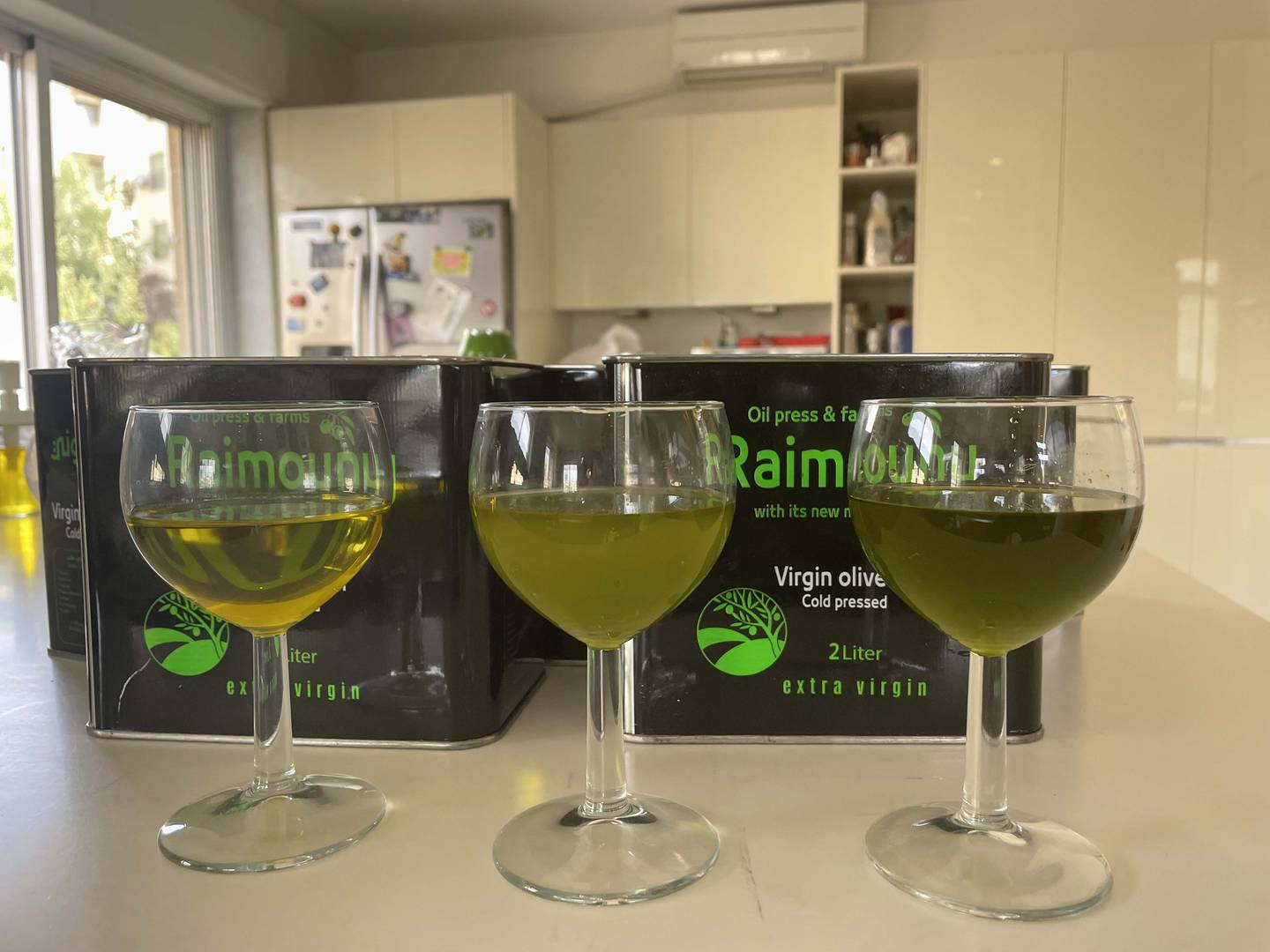 Three samples of Dibbeen olive oil: Left is from last year, middle is this year's crop pressed at 35 degree Celsius using Italian machines, and right is also this year's crop, pressed at 15 degree Celsius using German machines. Khaled Yacoub Oweis / The National