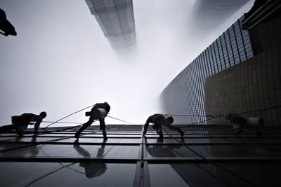 Chinese window cleaners scale the exterior of the Shanghai World Financial Center tower. Aly Song / Reuters