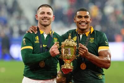 Willie Le Roux and Damian Willemse of South Africa pose for a photo with the The Webb Ellis Cup. Getty