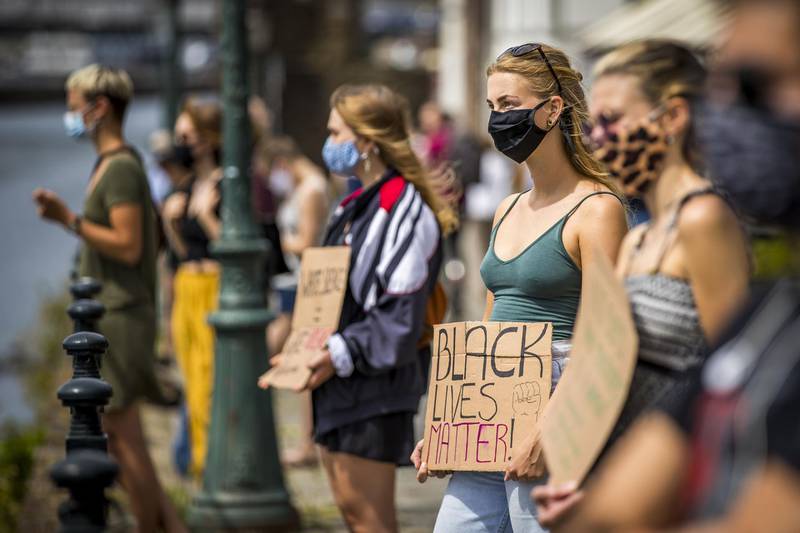 Activists hold placards reading 'Black Lives Matter' as they form a human chain in the center of Maastricht, The Netherlands.    AFP