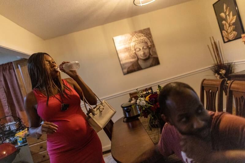 Ashley Tose, who is seven months pregnant, drinks from a bottle of water in Jackson. Reuters