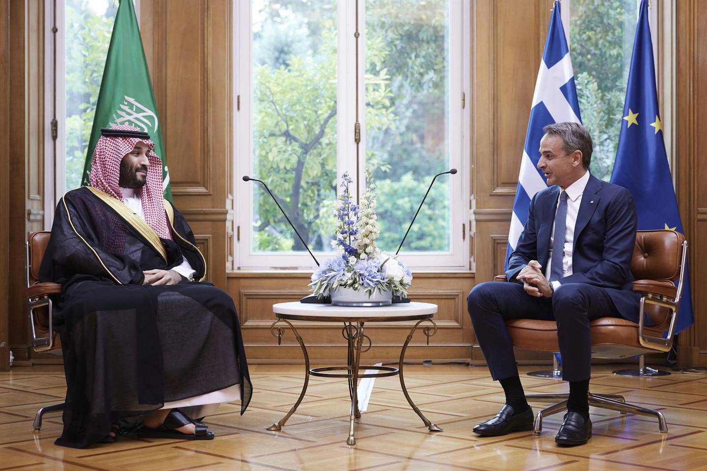 Greek Prime Minister Kyriakos Mitsotakis speaks to Saudi Arabia's Crown Prince Mohammed bin Salman during a meeting in Athens. Prince Mohammed has now travelled to France. AP