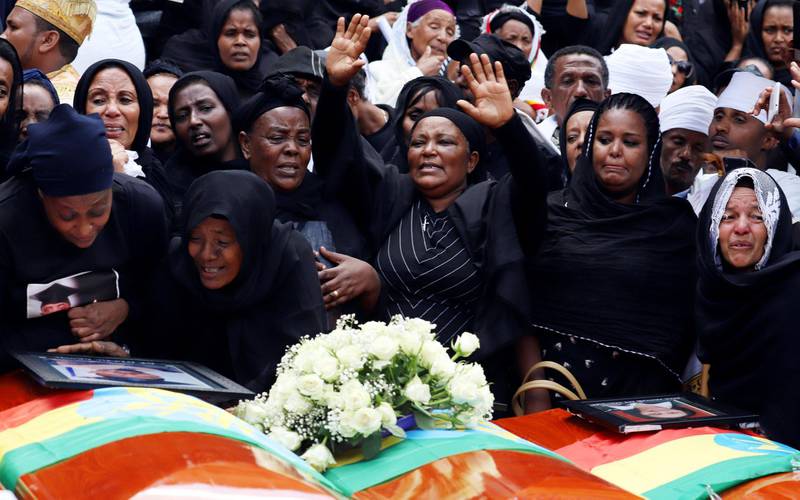 Mourners cry next to their relatives' coffins during the burial ceremony of the Ethiopian Airline Flight ET 302 crash victims at the Holy Trinity Cathedral Orthodox church in Addis Ababa, Ethiopia, March 17, 2019. REUTERS/Tiksa Negeri