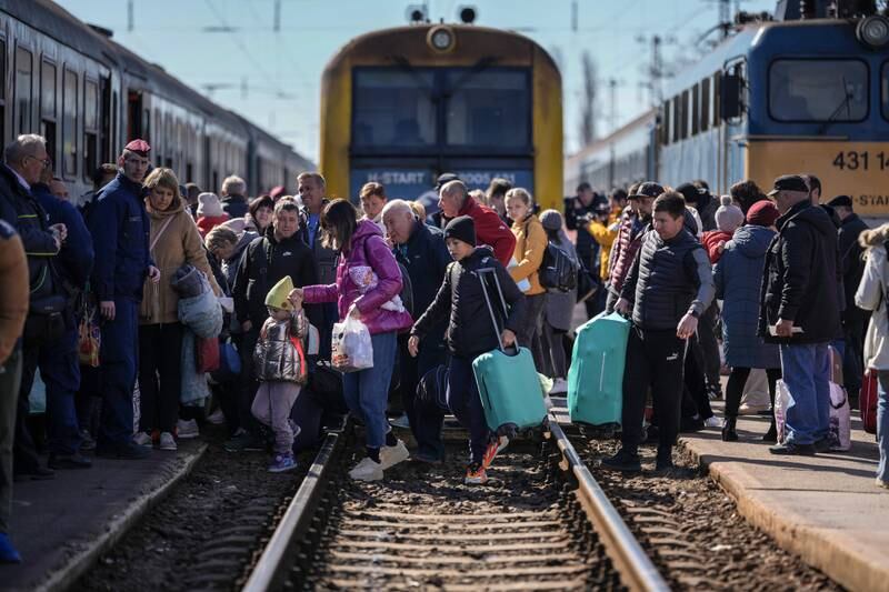 Ukrainians queue to board a train in Zahony, Hungary, on Saturday. Getty Images