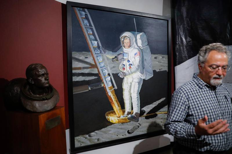 A portrait of astronaut Neil Armstrong stepping onto the surface of the moon is displayed behind museum director Dante Centuori.