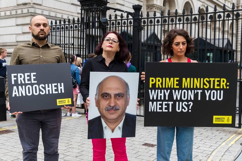 The family of jailed Anoosheh Ashoori, from left, son Aryan Ashoori, wife Sherry Izadi and daughter Elika Ashoori, call for UK Prime Minister Boris Johnson to meet them.