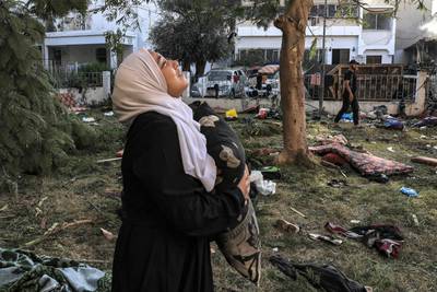 A woman among the debris outside Al Ahli Arab Hospital in central Gaza. AFP