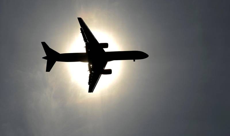 FILE PHOTO: A plane approaching Leeds Bradford airport passes in front of the sun in Leeds May 26, 2013. REUTERS/Philip Brown/File Photo