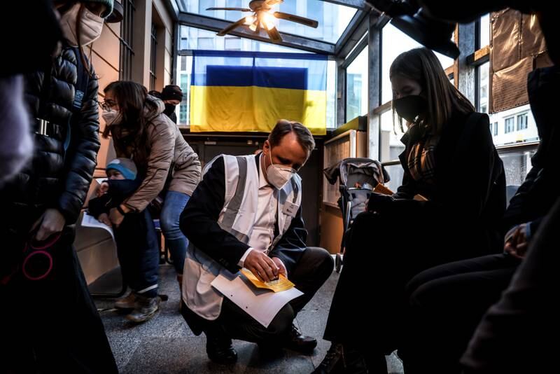 Ukrainians are registered by health workers while waiting to be vaccinated against the coronavirus at their country's embassy in German capital Berlin. EPA