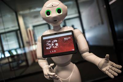 Robot "Pepper" welcomes guests arriving for the opening of the Vodafone 5G Lab in Duesseldorf, western Germany, on May 9, 2018.
At the lab, all devices able to be run under the 5th generation wireless systems (5G wireless network technology) will be tested for the network of mobile telecommunications operator Vodafone. / AFP PHOTO / dpa / Federico Gambarini / Germany OUT