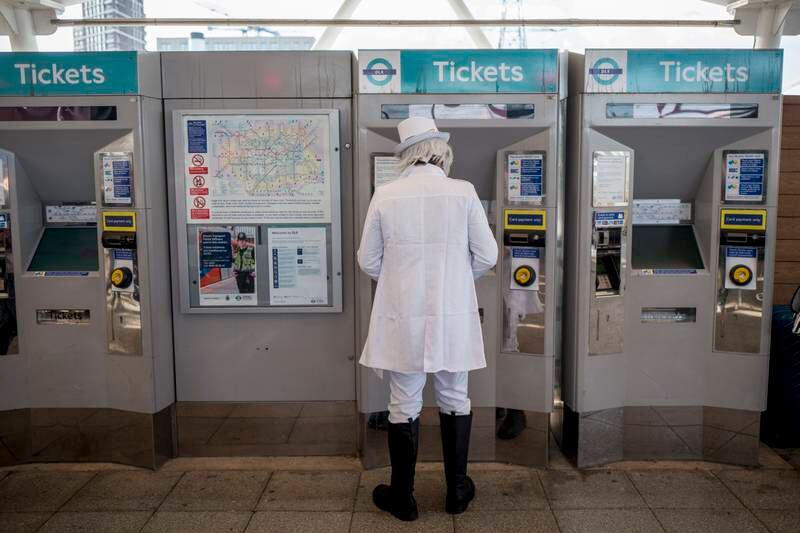 An MCM Comic Con cosplayer buys a tube ticket. EPA