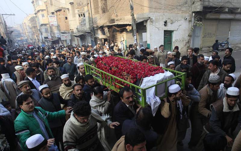People carry the coffin of a male student who was killed in Tuesday's attack on the Army Public School in Peshawar. Fayaz Aziz / Reuters