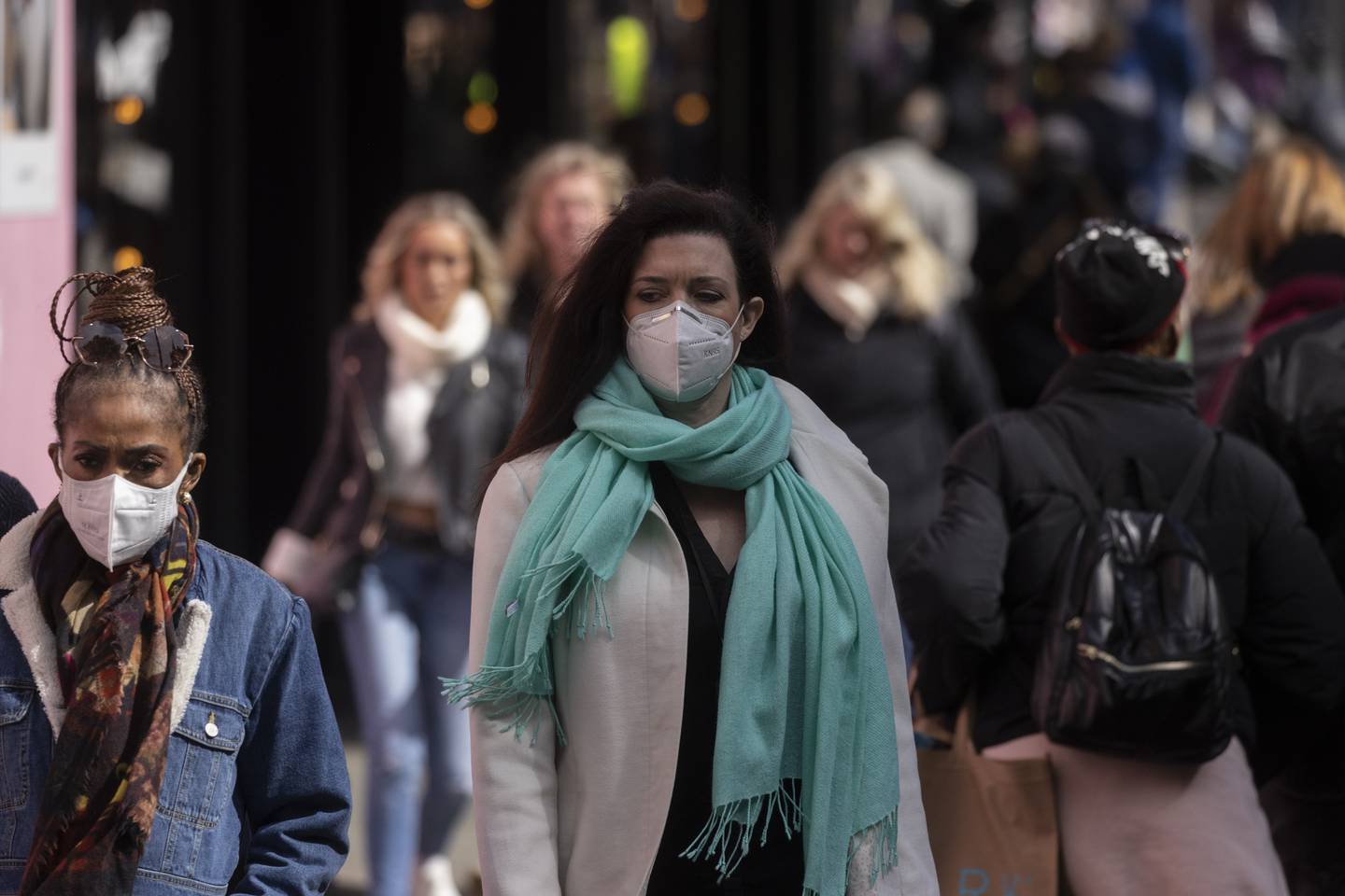 A woman wears a face mask while walking on Oxford Street, London, amid a rise in cases. Getty Images