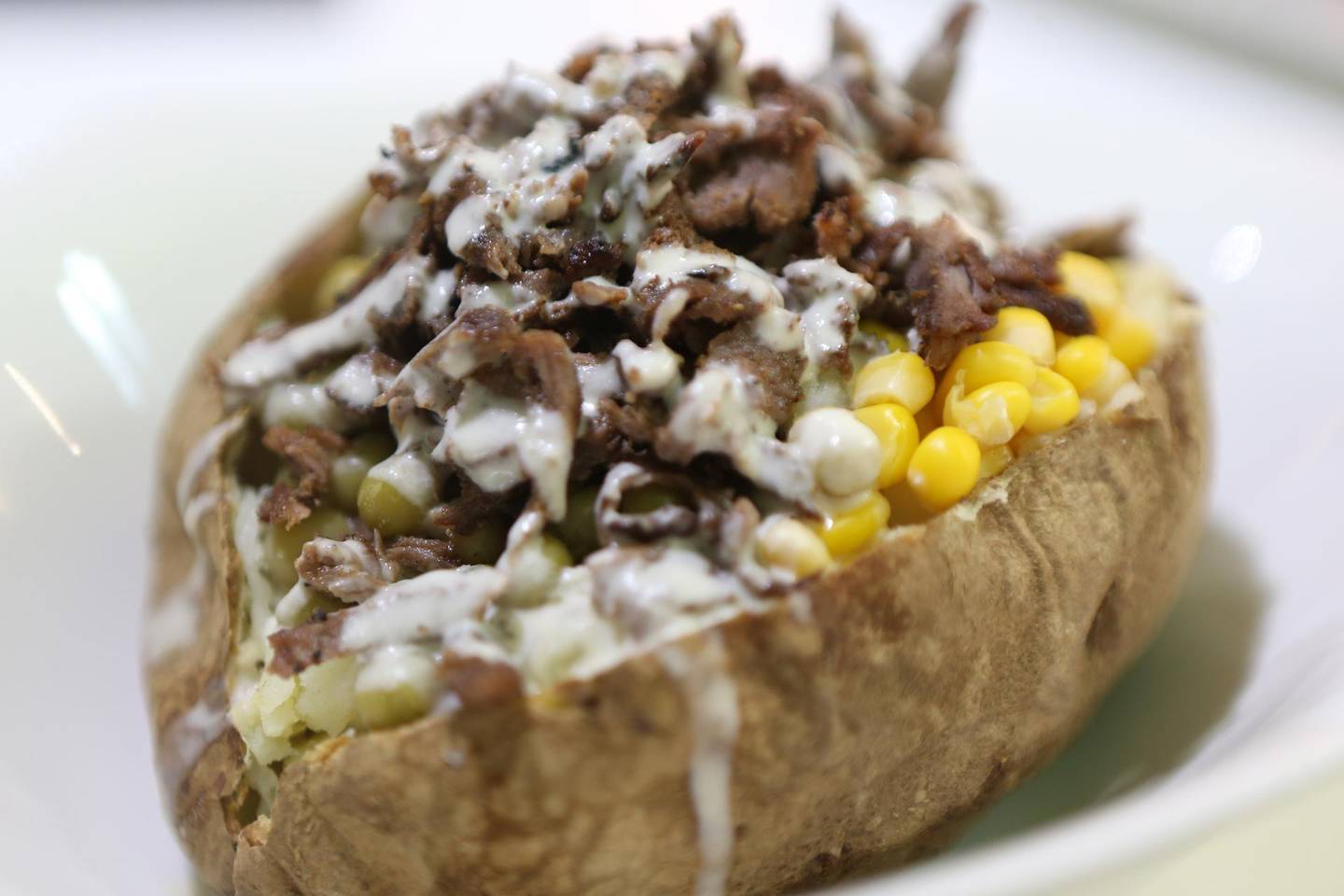 ABU DHABI, UNITED ARAB EMIRATES - - -  May 12, 2014 --- The baked potato with buffalo shaved on top at Shawarma Time restaurant on Najda Street in Abu Dhabi on Monday, May 12, 2014.    ( DELORES JOHNSON / The National )  ******** Reporter Jessica Hill  *******