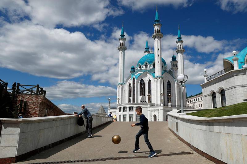 A boy plays with a ball near the Qolsharif Mosque, a day before the group C match between France and Australia at the 2018 World Cup in the Kazan Arena in Kazan, Russia. Pavel Golovkin / AP Photo
