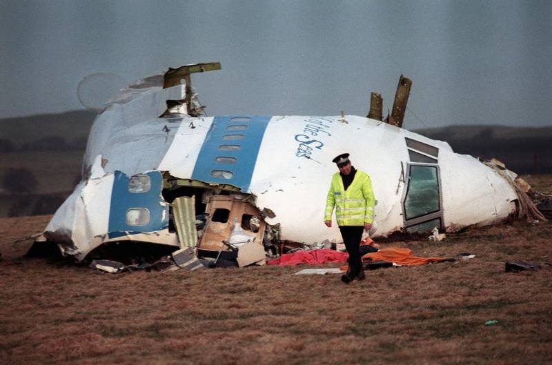 A policeman walking away from the damaged cockpit of the plane that exploded and crashed over Lockerbie, Scotland, in 1988.