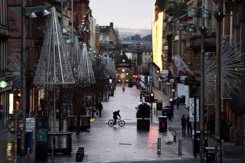 Pedestrians walk through central Glasgow. AFP