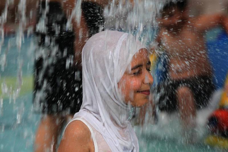A young girl cools off at an indoor water park during a heatwave in Baghdad. AFP