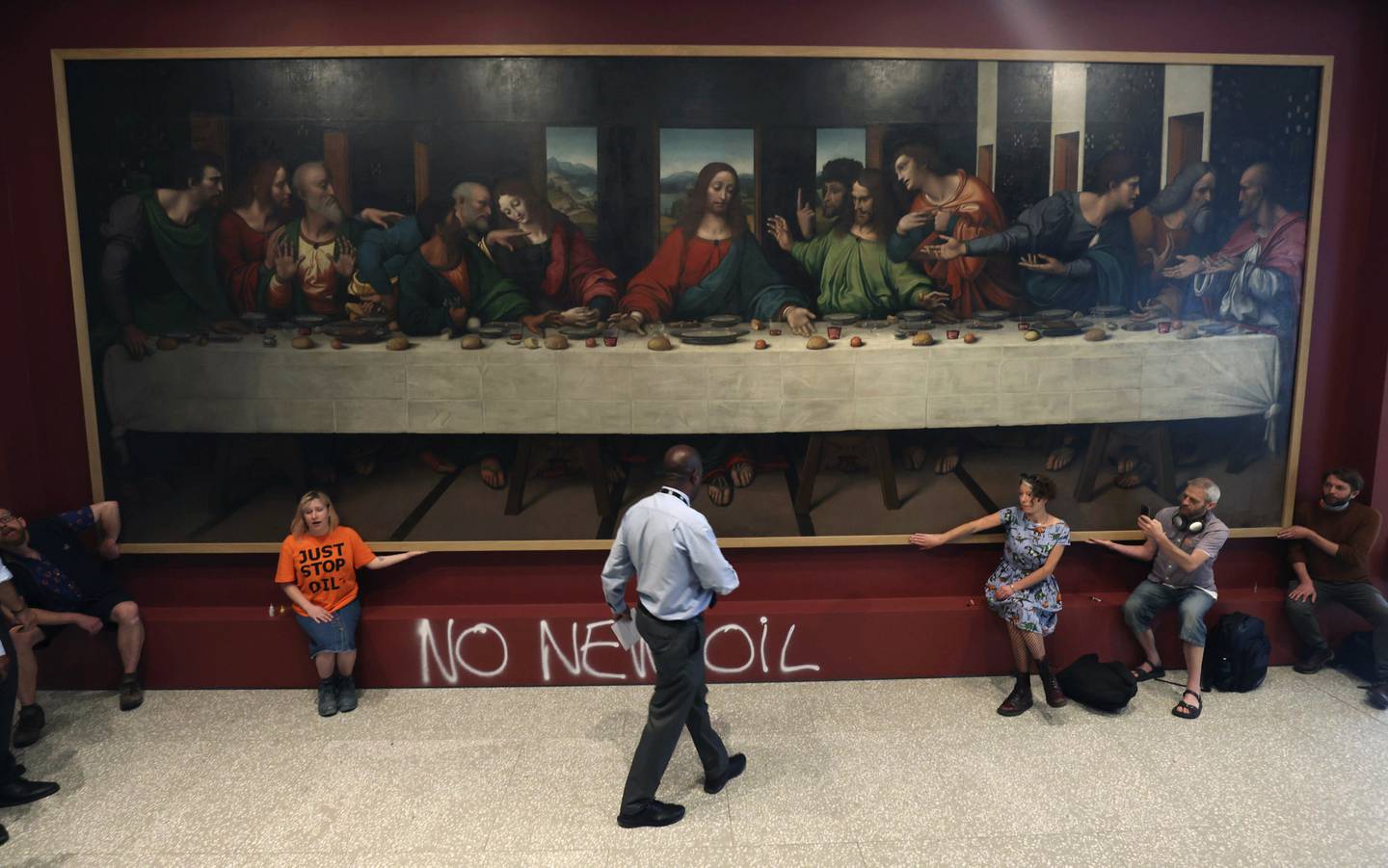 Just Stop Oil members glue their hands to the frame of a copy of Leonardo da Vinci's, 'The Last Supper', inside the Royal Academy, London. Photo: PA via AP