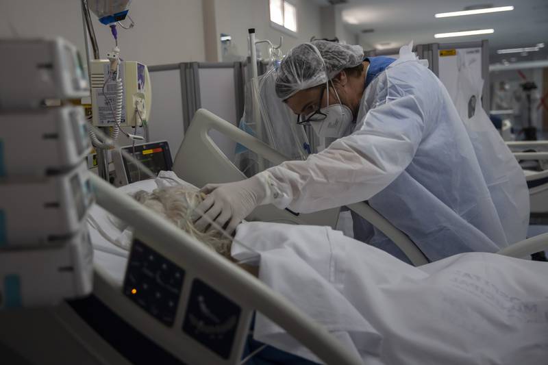 A health worker treats a Covid-19 patient in the intensive care unit of a hospital in Marica, Brazil. AP