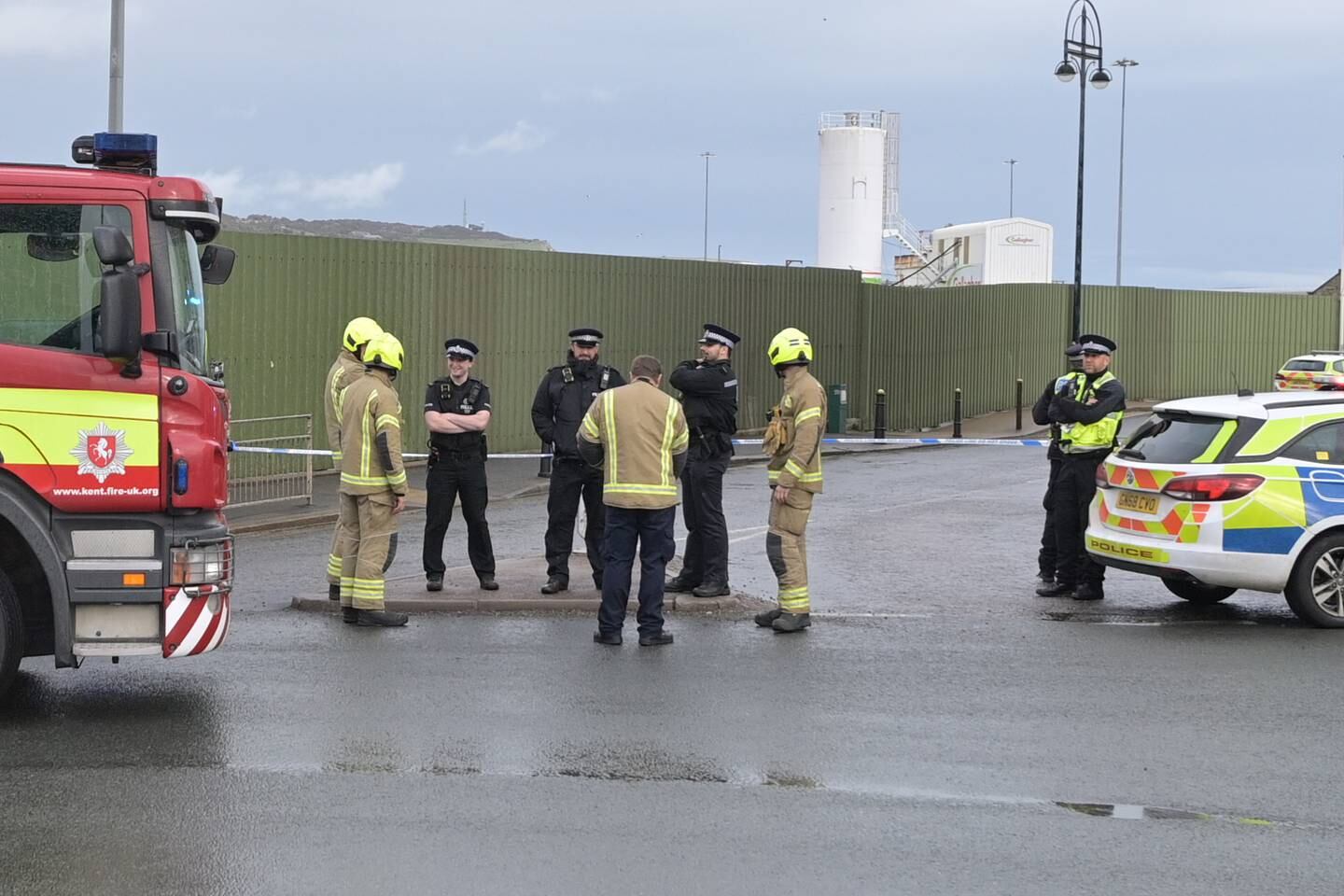 Police officers and a fire crew attends the scene of the suspected attack.    EPA