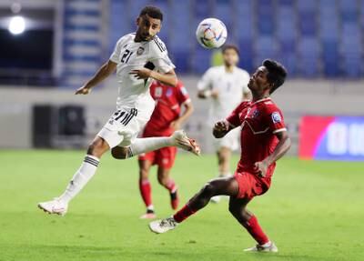UAE's Harib Abdalla and Aashish Chaudhary of Nepal battle for the ball.