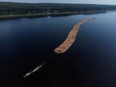 A tugboat pulls a timber raft down the Angara River near the settlement of Strelka, Russia. Reuters