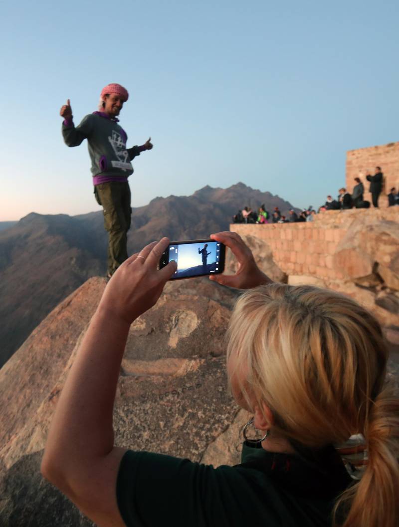 Tourists gather outside a church on the top of Mount Sinai. EPA